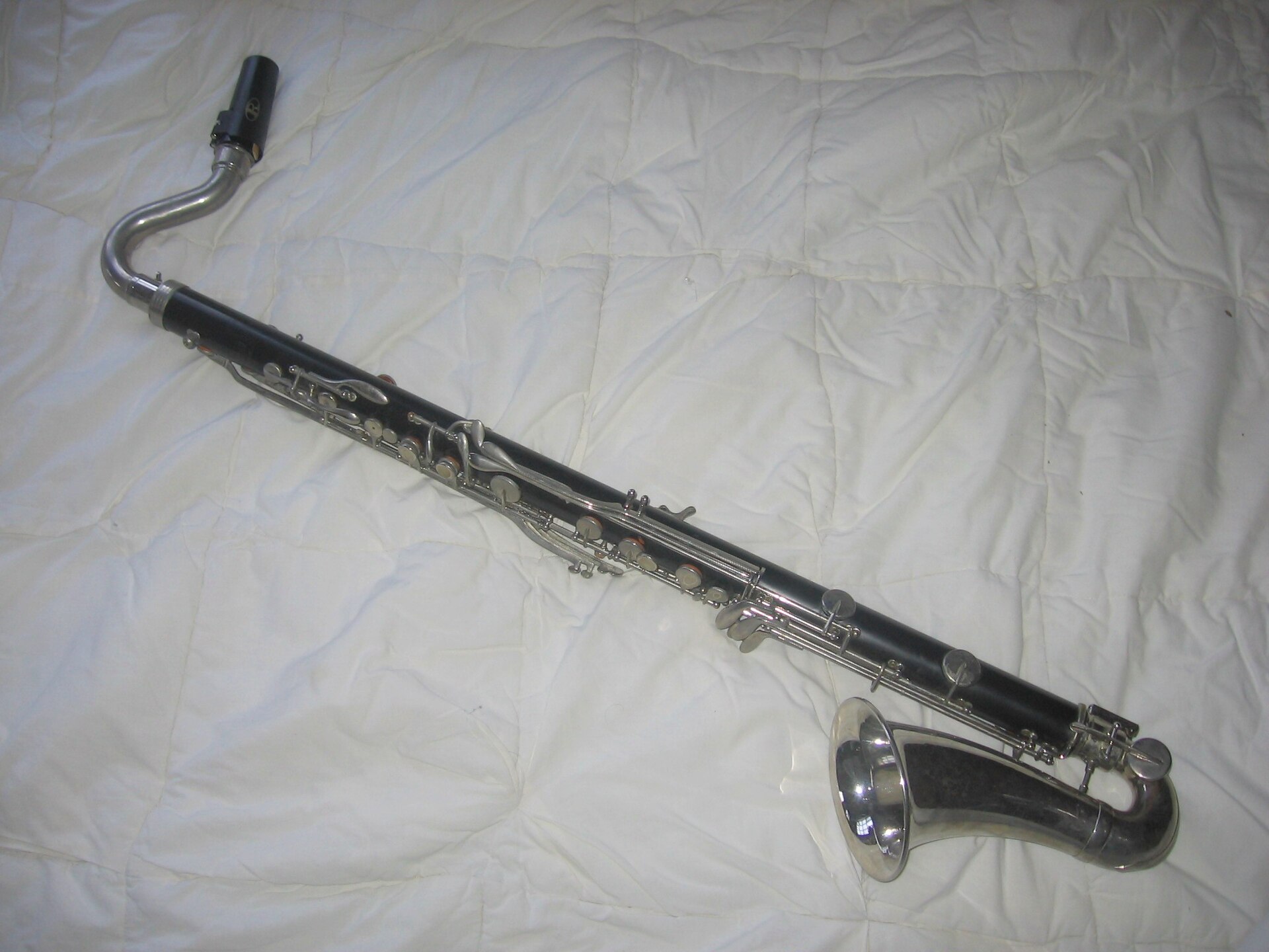 A bass clarinet photographed against a light background