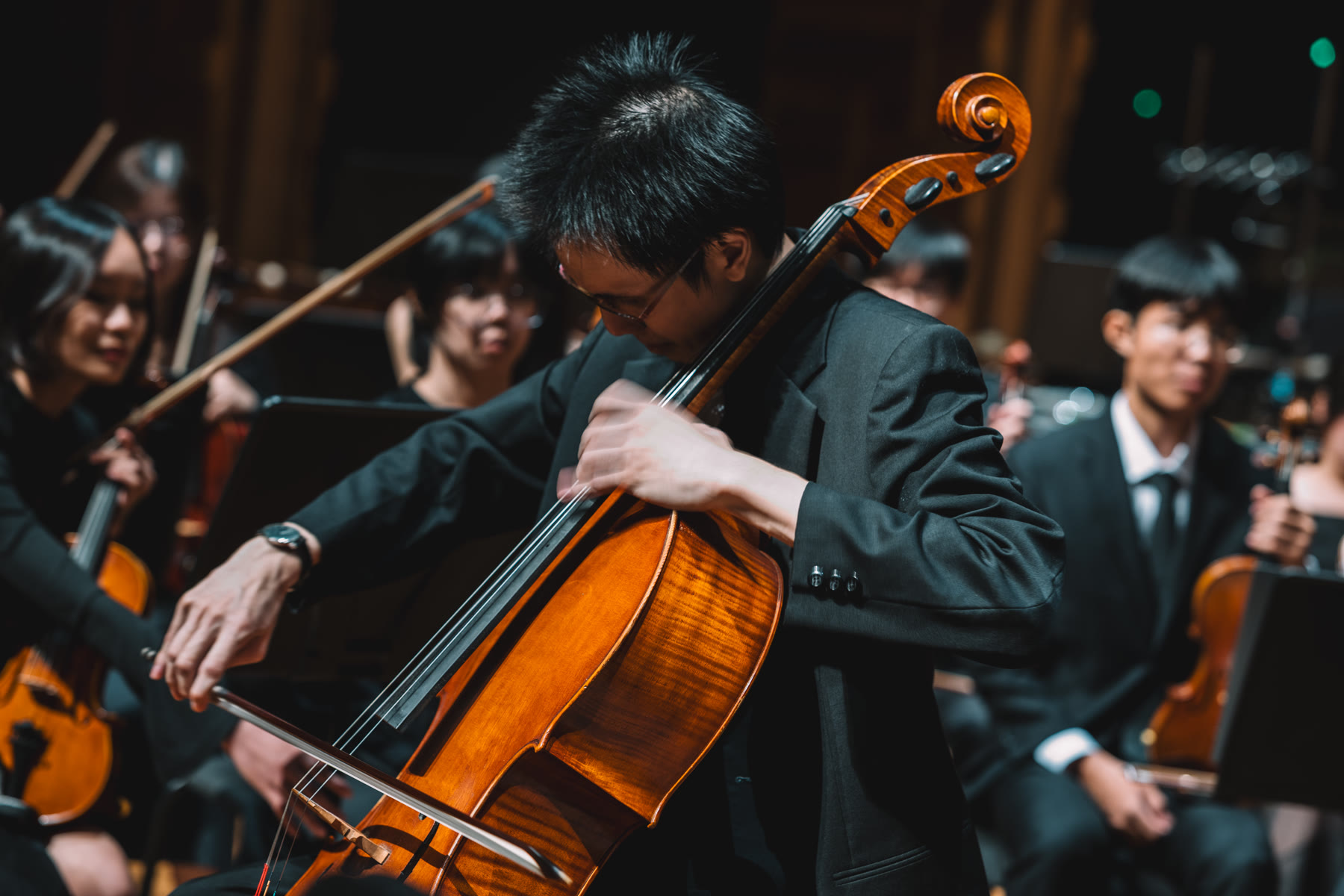NTUSO cellist performing with the string section