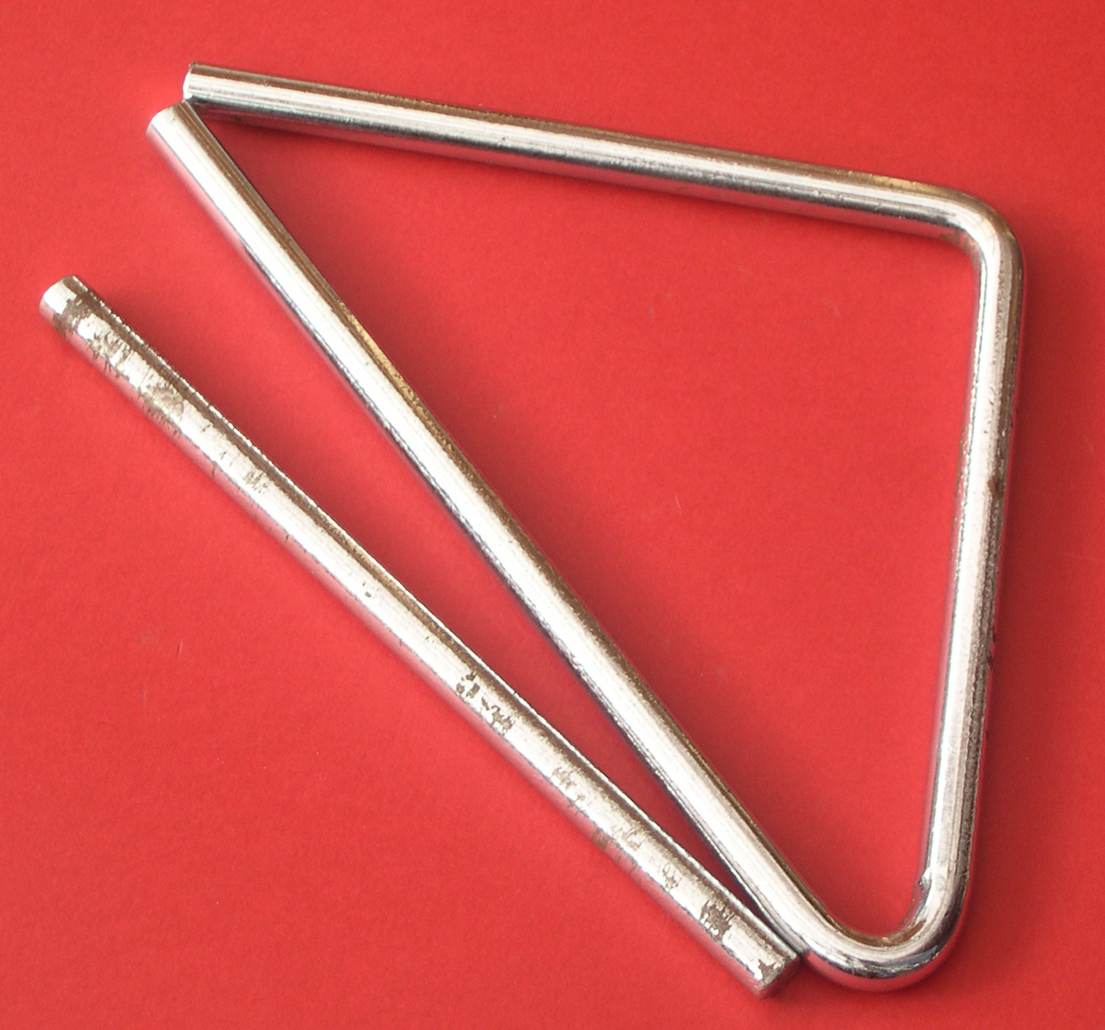 A metal orchestral triangle with its beater